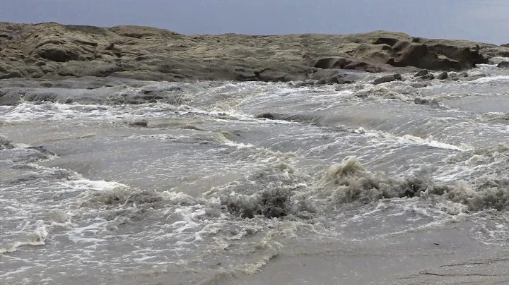 Rapid torrent during the rainy season flowing into the Pacific Ocean. Stock Footage 4k UHD 50 FPS